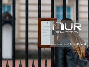 A member of the public looks at the official Royal announcement of the death of Prince Philip, Duke of Edinburgh is seen on the gates of Buc...