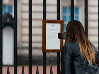 A member of the public looks at the official Royal announcement of the death of Prince Philip, Duke of Edinburgh is seen on the gates of Buc...