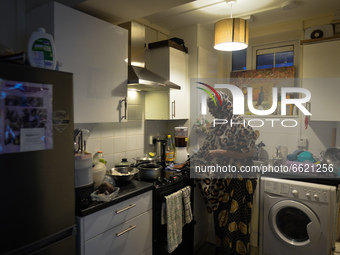 Ifrah Ahmed, a Somali-Irish living in Dublin, cleans her kitchen area after finishing preparing her iftar (fast-breaking) dinner inside her...