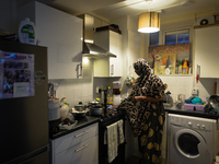 Ifrah Ahmed, a Somali-Irish living in Dublin, cleans her kitchen area after finishing preparing her iftar (fast-breaking) dinner inside her...