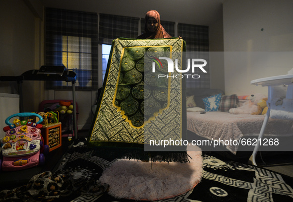 Ifrah Ahmed, a Somali-Irish living in Dublin, prepares a prayer mat for Maghrib, the fourth of the five required daily prayers, inside her a...