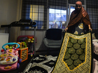 Ifrah Ahmed, a Somali-Irish living in Dublin, prepares a prayer mat for Maghrib, the fourth of the five required daily prayers, inside her a...