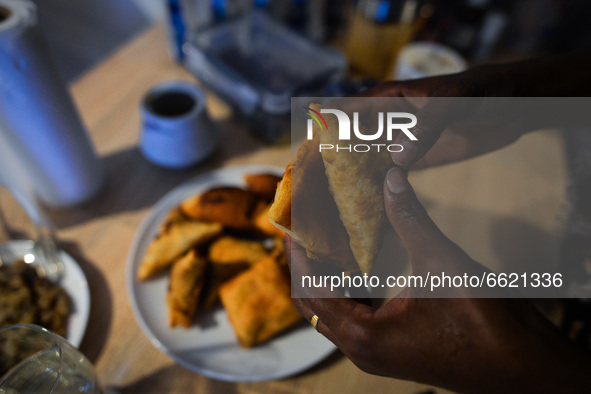 After finishing Maghrib prayer, Ifrah Ahmed, a Somali-Irish living in Dublin, eating Somali food including Mandazi (African donuts) and Samb...