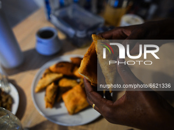 After finishing Maghrib prayer, Ifrah Ahmed, a Somali-Irish living in Dublin, eating Somali food including Mandazi (African donuts) and Samb...