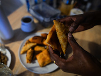 After finishing Maghrib prayer, Ifrah Ahmed, a Somali-Irish living in Dublin, eating Somali food including Mandazi (African donuts) and Samb...