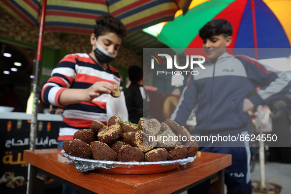 A Palestinian vender prepare Falafel during the Muslim fasting month of Ramadan in Gaza City on April 16, 2021, amid the COVID-19 pandemic....