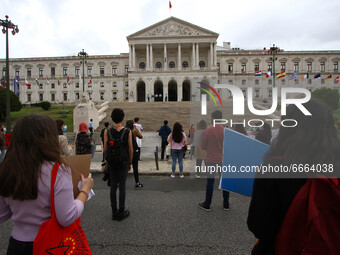 Students wearing protective masks and holding placards alluding to the university crisis march through the different streets of Lisbon. Apri...