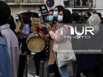 Students wearing protective masks and holding placards alluding to the university crisis march through the different streets of Lisbon. Apri...