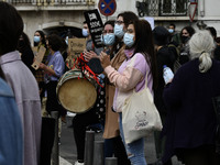 Students wearing protective masks and holding placards alluding to the university crisis march through the different streets of Lisbon. Apri...