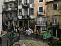 Students wearing protective masks and holding placards alluding to the university crisis march through the different streets of Lisbon. Apri...