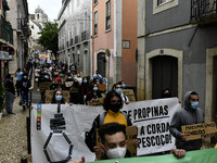 Students wearing protective masks and holding placards alluding to the university crisis march through the different streets of Lisbon. Apri...