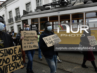 Students wearing protective masks and holding placards alluding to the university crisis march through the different streets of Lisbon. Apri...