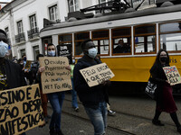 Students wearing protective masks and holding placards alluding to the university crisis march through the different streets of Lisbon. Apri...