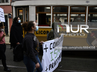 Students wearing protective masks and holding placards alluding to the university crisis march through the different streets of Lisbon. Apri...