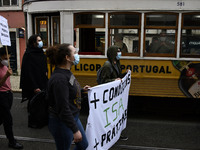 Students wearing protective masks and holding placards alluding to the university crisis march through the different streets of Lisbon. Apri...