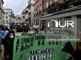 Students wearing protective masks and holding placards alluding to the university crisis march through the different streets of Lisbon. Apri...