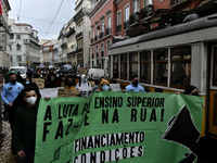 Students wearing protective masks and holding placards alluding to the university crisis march through the different streets of Lisbon. Apri...