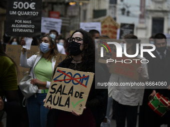 Students wearing protective masks and holding placards alluding to the university crisis march through the different streets of Lisbon. Apri...