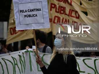 Students wearing protective masks and holding placards alluding to the university crisis march through the different streets of Lisbon. Apri...