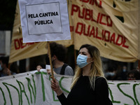 Students wearing protective masks and holding placards alluding to the university crisis march through the different streets of Lisbon. Apri...