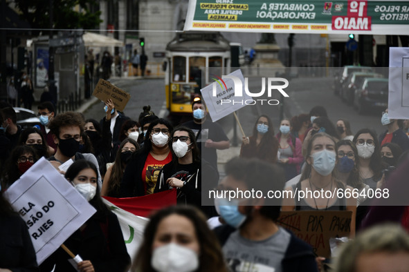 Students wearing protective masks and holding placards alluding to the university crisis march through the different streets of Lisbon. Apri...