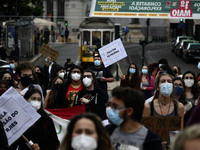 Students wearing protective masks and holding placards alluding to the university crisis march through the different streets of Lisbon. Apri...