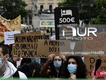 Students wearing protective masks and holding placards alluding to the university crisis march through the different streets of Lisbon. Apri...