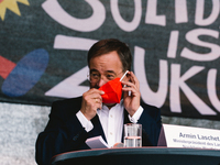 Prime Minister Armin Laschet is seen placing face mask back after speech during the drive in labor day rally in Duesseldorf, germany on May...