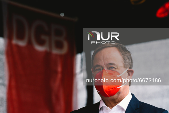 Prime Minister Armin Laschet is seen with red face mask back after speech during the drive in labor day rally in Duesseldorf, germany on May...