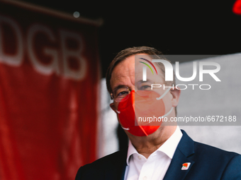 Prime Minister Armin Laschet is seen with red face mask back after speech during the drive in labor day rally in Duesseldorf, germany on May...