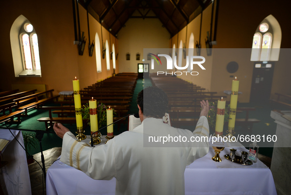 Father Krzysztof Sikora during a private prayer at the closed and empty Roman Catholic Church 'Our Lady Star Of The Sea' in Roundstone. Due...