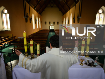 Father Krzysztof Sikora during a private prayer at the closed and empty Roman Catholic Church 'Our Lady Star Of The Sea' in Roundstone. Due...