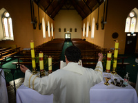 Father Krzysztof Sikora during a private prayer at the closed and empty Roman Catholic Church 'Our Lady Star Of The Sea' in Roundstone. Due...