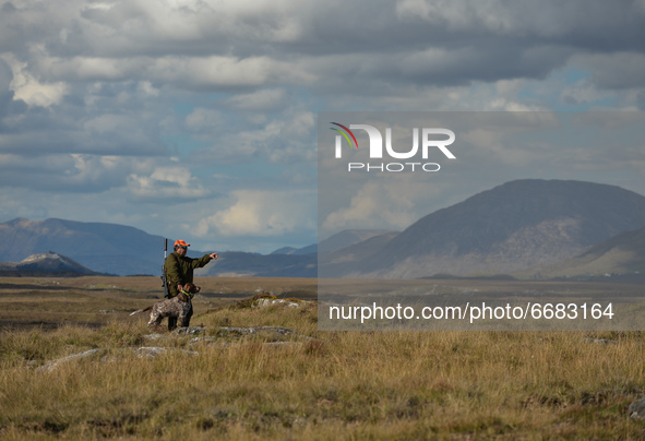 Father Krzysztof Sikora seen with his dog 'Rambo' near to the Gowla Fishery, situated in central Connemara, among one of the most beautiful...