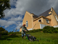 Father Krzysztof Sikora cuts the grass around the 'Our Lady Star Of The Sea' Roman Catholic church in Roundstone, Connemara.

Geographically...