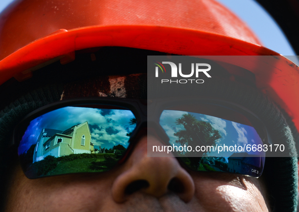 The reflection of the church in Roundstone in the sunglasses of priest Krzysztof Sikora, who cuts the grass around the church.

Geographical...