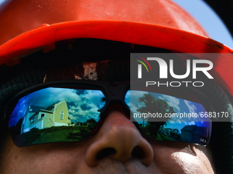 The reflection of the church in Roundstone in the sunglasses of priest Krzysztof Sikora, who cuts the grass around the church.

Geographical...