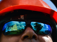 The reflection of the church in Roundstone in the sunglasses of priest Krzysztof Sikora, who cuts the grass around the church.

Geographical...