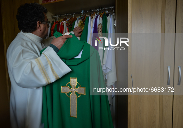 Father Krzysztof Sikora inspects the chasuble in the sacristy of the Roman Catholic Church 'Our Lady Star Of The Sea' in Roundstone, Connema...