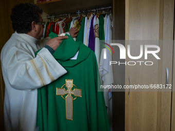 Father Krzysztof Sikora inspects the chasuble in the sacristy of the Roman Catholic Church 'Our Lady Star Of The Sea' in Roundstone, Connema...