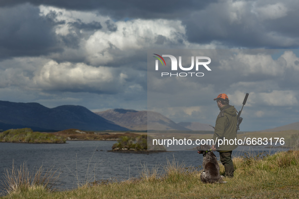 Father Krzysztof Sikora seen with his dog 'Rambo' near to the Gowla Fishery, situated in central Connemara, among one of the most beautiful...