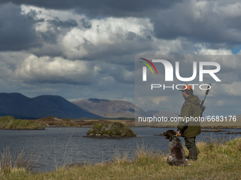 Father Krzysztof Sikora seen with his dog 'Rambo' near to the Gowla Fishery, situated in central Connemara, among one of the most beautiful...