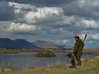 Father Krzysztof Sikora seen with his dog 'Rambo' near to the Gowla Fishery, situated in central Connemara, among one of the most beautiful...