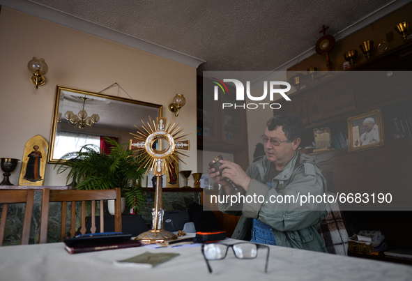 Father Krzysztof Sikora checks the liturgical vessels used during the celebration of the Holy Mass inside the presbytery in Roundstone.

Geo...