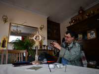 Father Krzysztof Sikora checks the liturgical vessels used during the celebration of the Holy Mass inside the presbytery in Roundstone.

Geo...