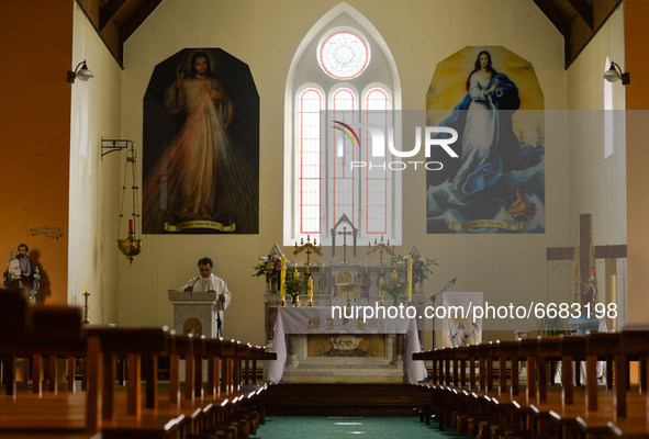 Father Krzysztof Sikora during a private prayer at the closed and empty Roman Catholic Church 'Our Lady Star Of The Sea' in Roundstone. Due...