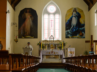 Father Krzysztof Sikora during a private prayer at the closed and empty Roman Catholic Church 'Our Lady Star Of The Sea' in Roundstone. Due...