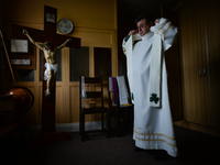 Father Krzysztof Sikora is getting ready for private prayer at the closed Roman Catholic Church 'Our Lady Star Of The Sea' in Roundstone. Du...