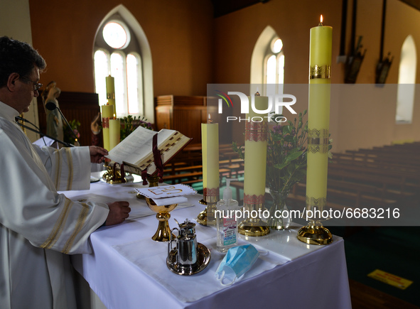 Father Krzysztof Sikora during a private prayer at the closed and empty Roman Catholic Church 'Our Lady Star Of The Sea' in Roundstone. Due...