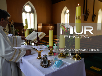 Father Krzysztof Sikora during a private prayer at the closed and empty Roman Catholic Church 'Our Lady Star Of The Sea' in Roundstone. Due...